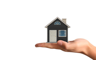 Mortgage concept by house from  hand