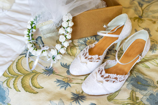 Wedding wreath and white bride shoes. Wedding accessories.