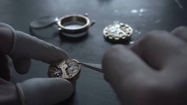 Watch maker is repairing a vintage automatic watch.
