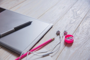 working place with graphic tablet with school supplies on wooden office desk table 
