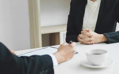 Business concept - Executives at desk discussion sales performance in a office.