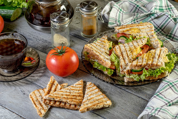 Panini sandwich with ham, tomato and lettuce.