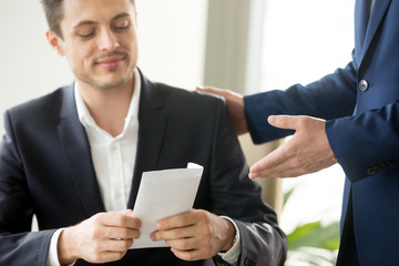 Happy corrupted businessman accepting bribe, male hand giving smiling office worker envelope salary...