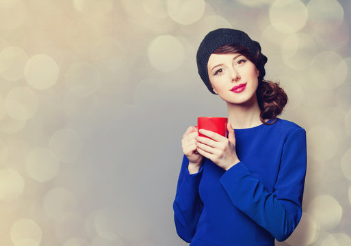 women in blue dress with red cup