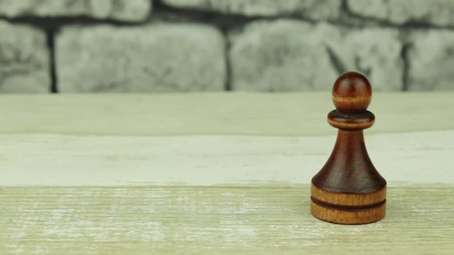 Chess pawn on a brick background