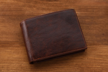 Brown man wallet on wooden background