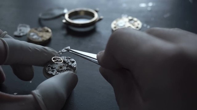 Watch maker is repairing a vintage automatic watch.