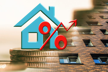 The percent symbol on the background of real estate and money .The concept of mortgage lending .
