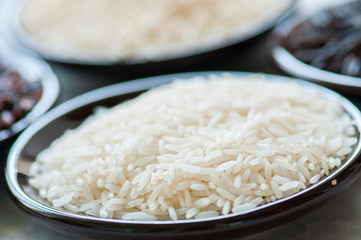 Basmati rice in a plate on a white stone background. Toned.