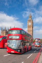 Obraz na płótnie Canvas London with red buses against Big Ben in England, UK