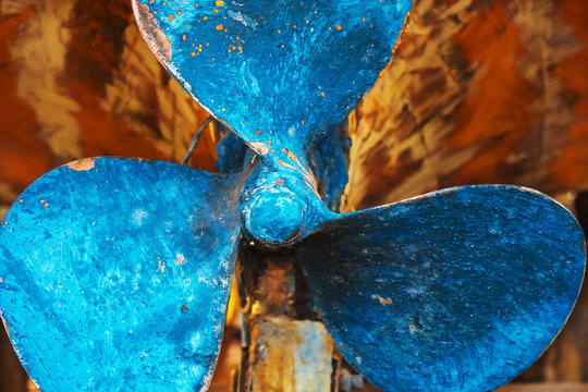 Close up image of clear old blue boat propeller