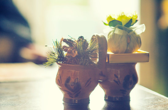Antique Clay dishes with sashet on room background.
