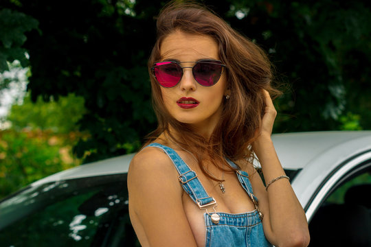 portrait of young beautiful brunette in sunglasses