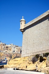 Corner tower on Fort Saint Angelo with views towards Valletta, Vittoriosa, Malta.