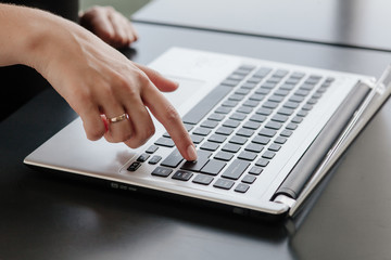 Hands of a beautiful girl on laptop, notebook