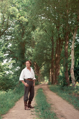 Historical man standing on country road