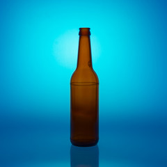 bottle of beer without any logos on blue background