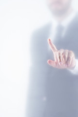 cropped view of businessman in suit pointing behind glass, isolated on white