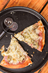 Triangle slices of fresh baked pizza with mushrooms cheese ham ketchup