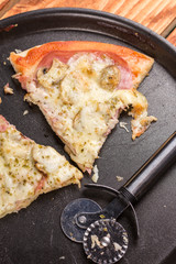 Triangle slices of fresh baked pizza with mushrooms cheese ham ketchup