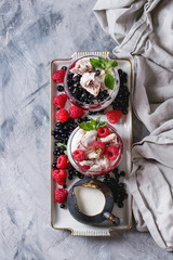Traditional summer dessert Eton Mess. Broken meringue with whipped cream, berry jam, fresh...