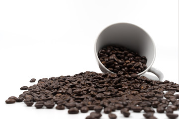 Roasted coffee beans in a cup of coffee