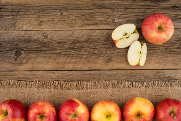 Red apples on the old wooden table.
