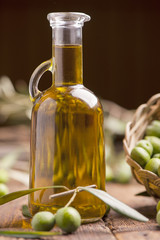 Olive oil and olives on wooden rustic table