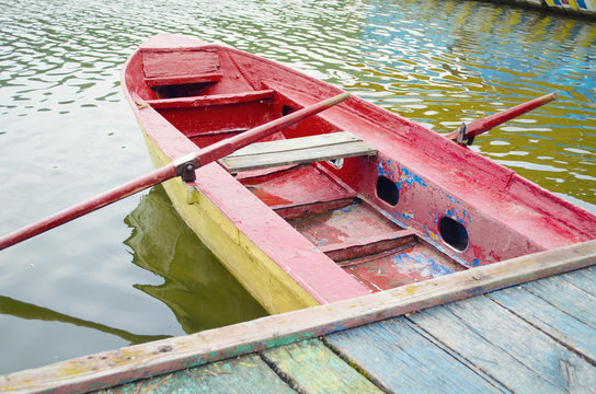 Traditional colorful wooden boat on water.