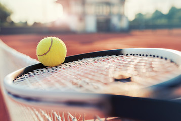 Tennis ball with racket on the tennis court. Sport, recreation concept