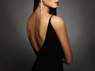 woman in a black sexy dress and jewelry