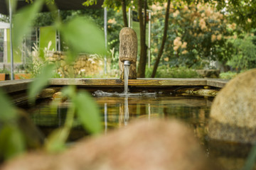 A faucet in a detached garden pond.
