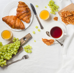 Breakfast in bed with croissants, raspberry and blackberry bruschetta.  Morning treat concept.
