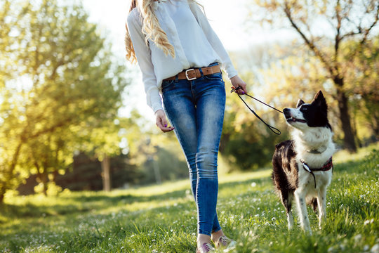 Beautiful woman and dog enjoying their time in nature