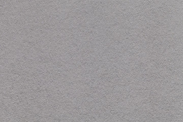 Texture of old light gray paper closeup. Structure of a dense cardboard. The silver background.