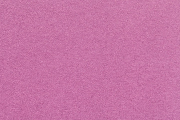 Fototapeta premium Texture of old dark pink paper closeup. Structure of a dense cardboard. The rose background.