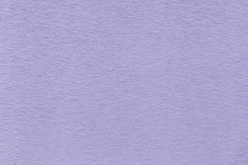 Texture of old light violet paper closeup. Structure of a dense cardboard. The lavender background.