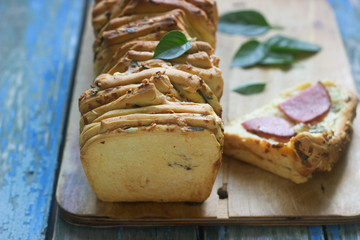 Homemade bread with cheese, salami and herbs