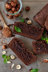 Homemade chocolate brownies with nuts on a metal, grunge background