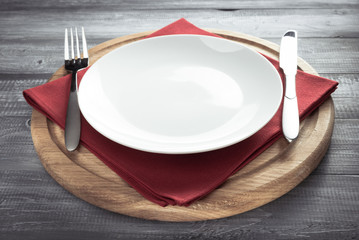 plate, knife and fork on rustic background