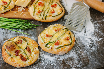 Mini pizza with asparagus. Traditional small pizza for personal eating filling with cheese, tomatoes and asparagus.