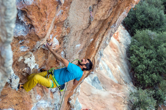 Mature Rock Climber holds rope in teeth