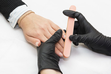 The process of manicure in the beauty salon is shot close-up 