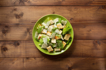 caesar salad in plate at wood