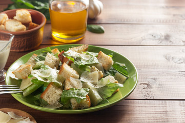 caesar salad and ingredients at wood