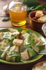 caesar salad and ingredients at wood