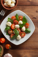 caprese salad in plate at wood