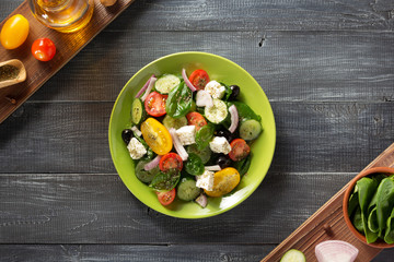 fresh greek salad in plate and ingredients