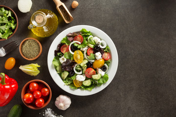 fresh greek salad in plate and ingredients