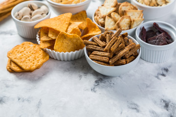 Salty beer snacks in whit bowls